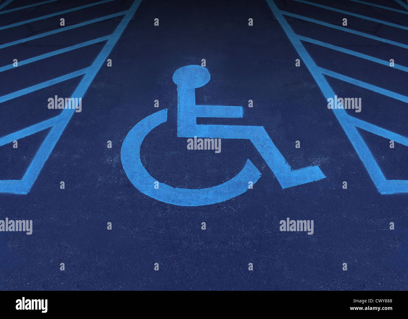 Handicapped and disabled symbol as a parking space with a wheelchair painted on asphalt as a health care and medical icon of reserved space for accessibility of the physically challenged. Stock Photo