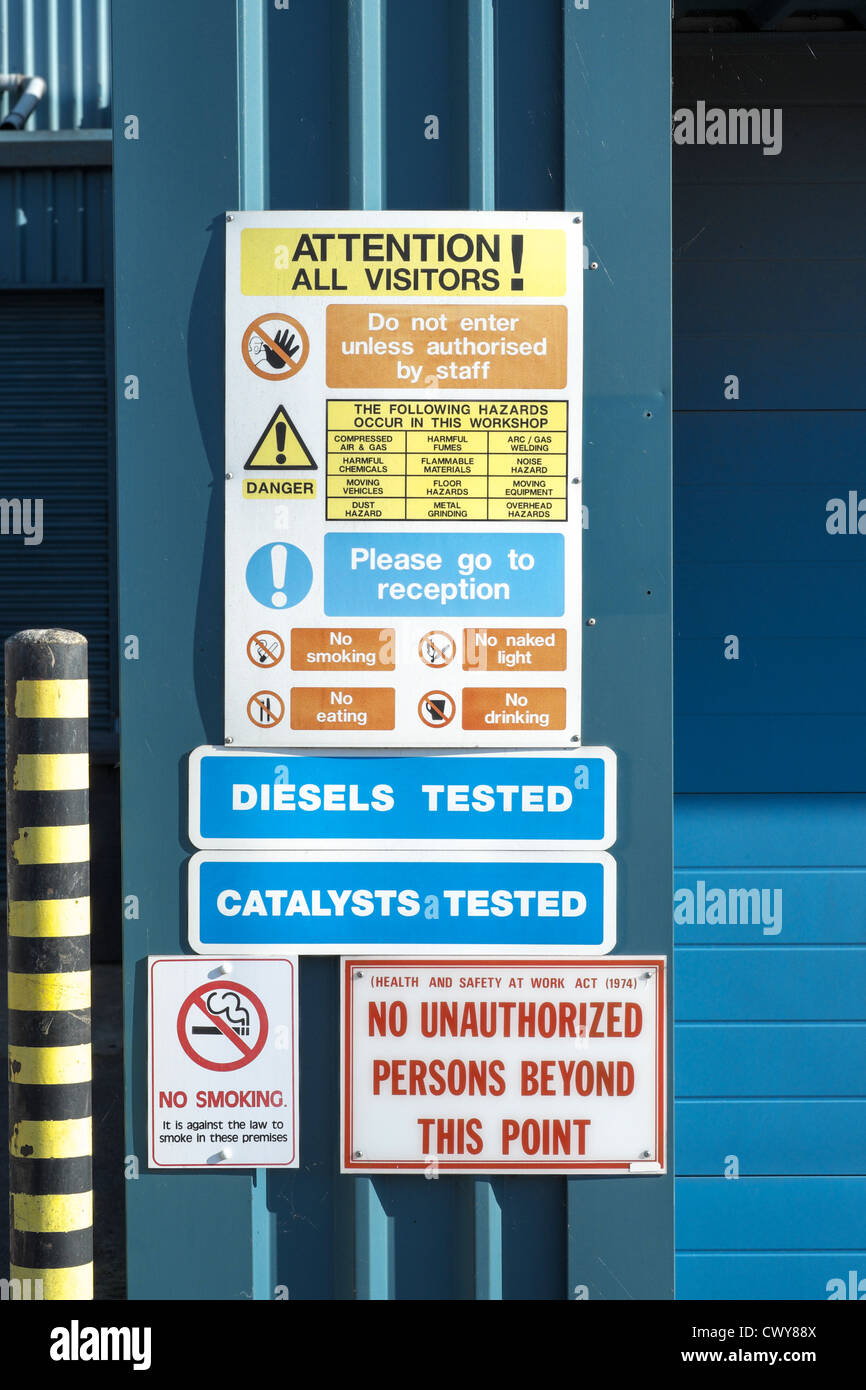 Health and safety notices at the entrance to a UK garage or motor
