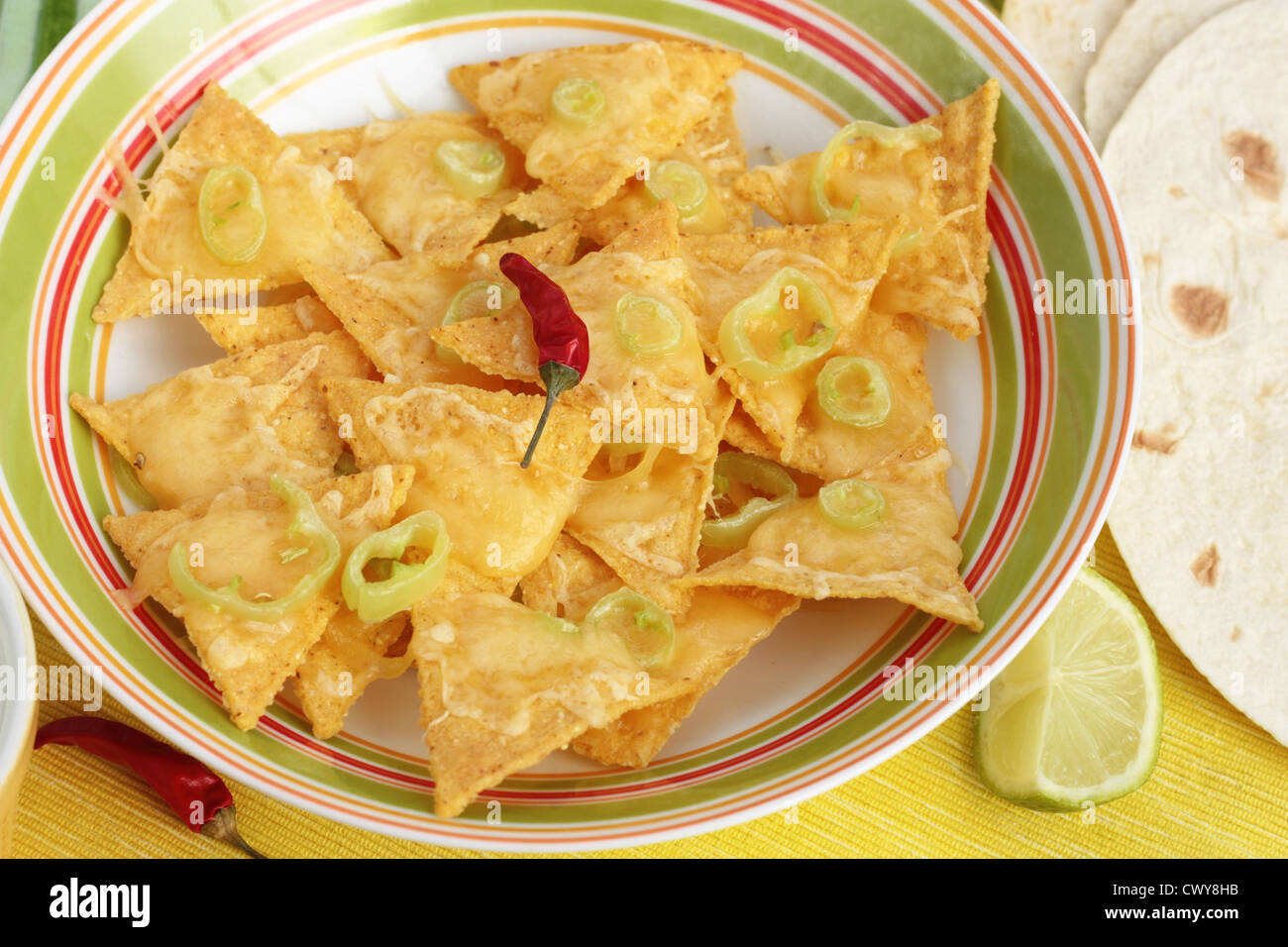 Nachos covered in melted cheese and jalapeno peppers. With tortillas