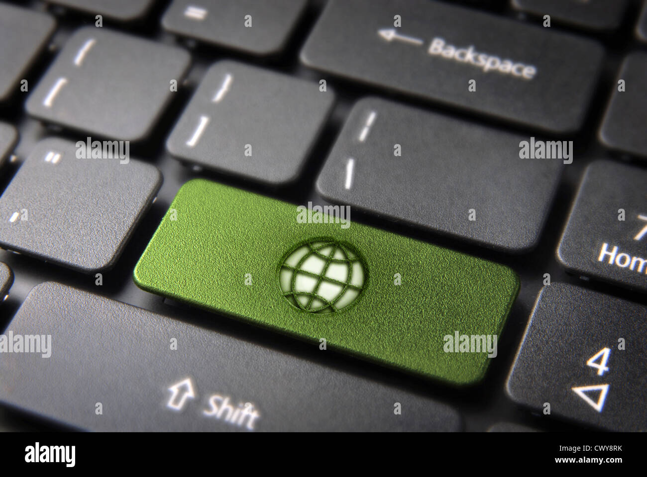 Global go green key with earth icon on laptop keyboard. Included clipping path, so you can easily edit it. Stock Photo