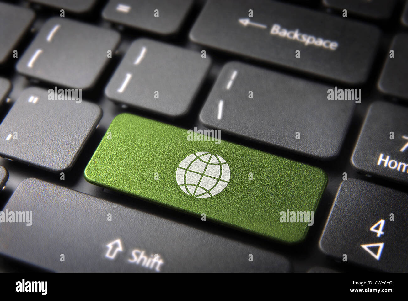 Global go green key with Earth icon on laptop keyboard. Included clipping path, so you can easily edit it. Stock Photo