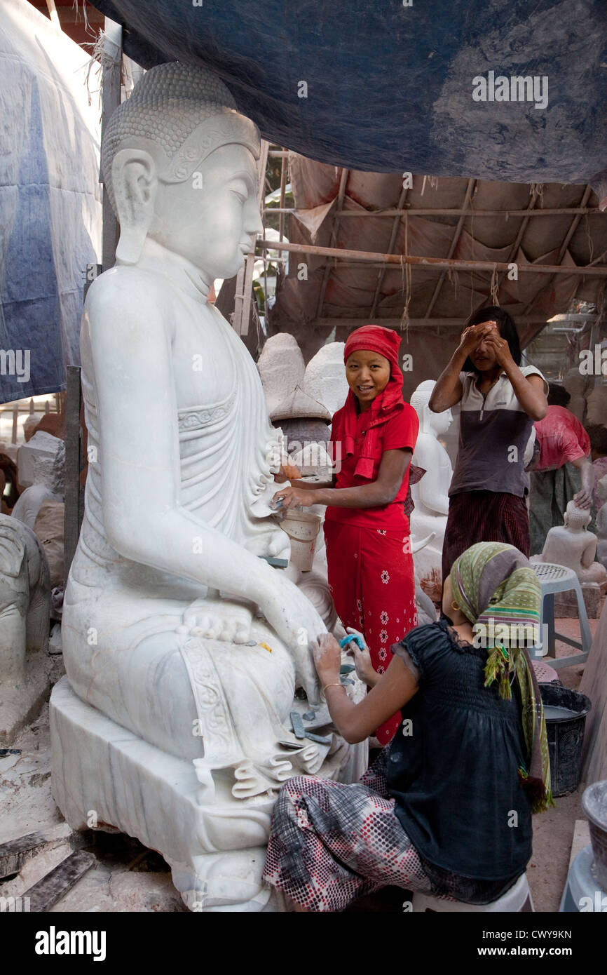 Myanmar, Burma, Mandalay. Buddha Sculptors Carve, Sand, and Polish Buddhas from Stone. Many are exported to China. Stock Photo