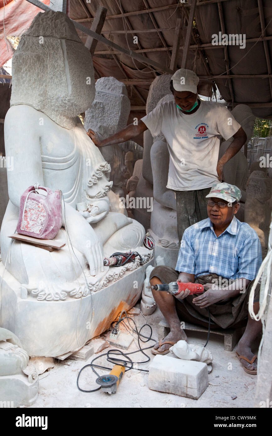 Myanmar, Burma, Mandalay. Buddha Sculptors Carve, Sand, and Polish Buddhas from Stone. Many are exported to China. Stock Photo