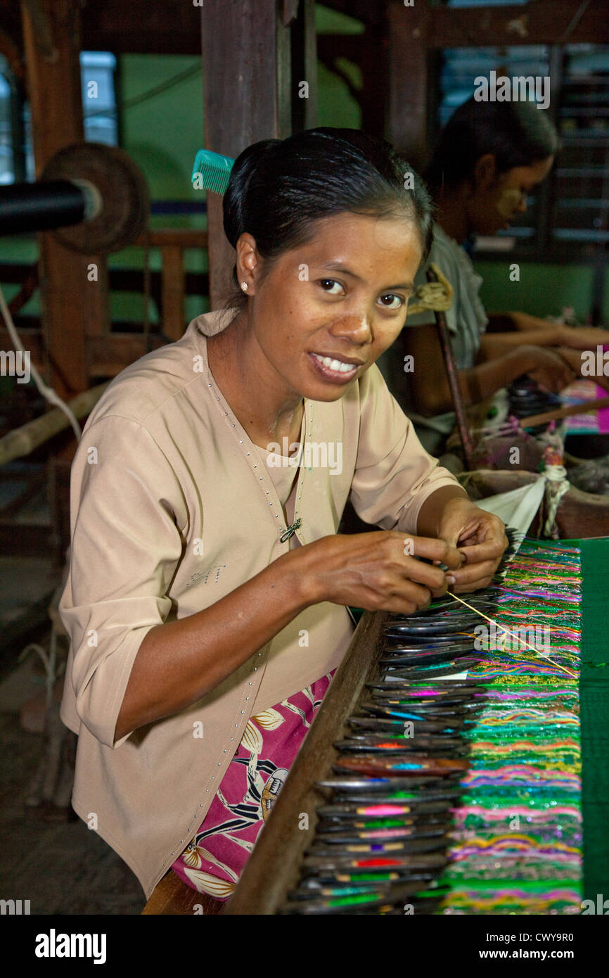 Myanmar, Burma. Mandalay. Woman Weaving Textiles. Stock Photo