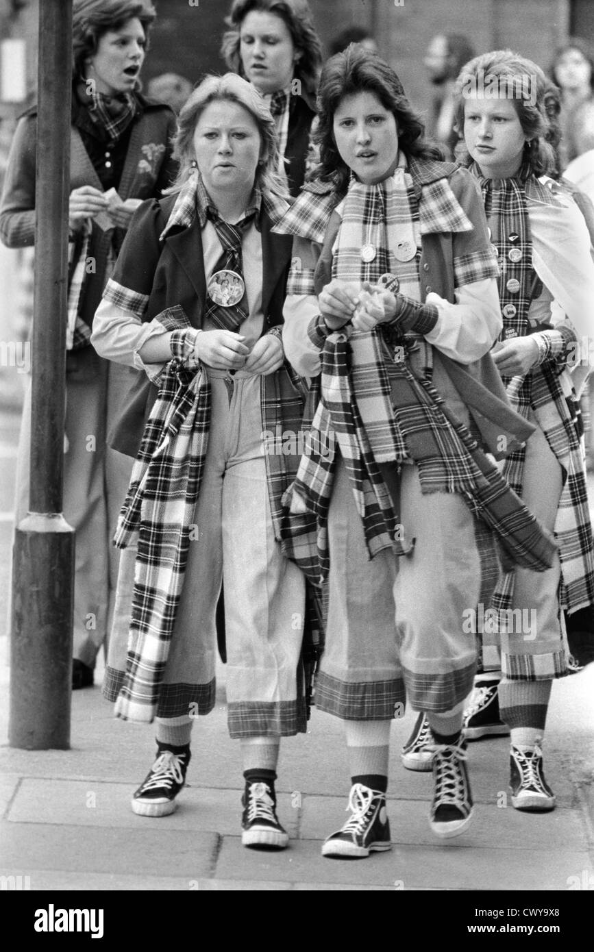 Bay City Rollers pop group, a 1970s boy band. Teenage girl fans wait for  the Rollers to arrive. They are on a tour bus and will give a concert that  night. Tartan