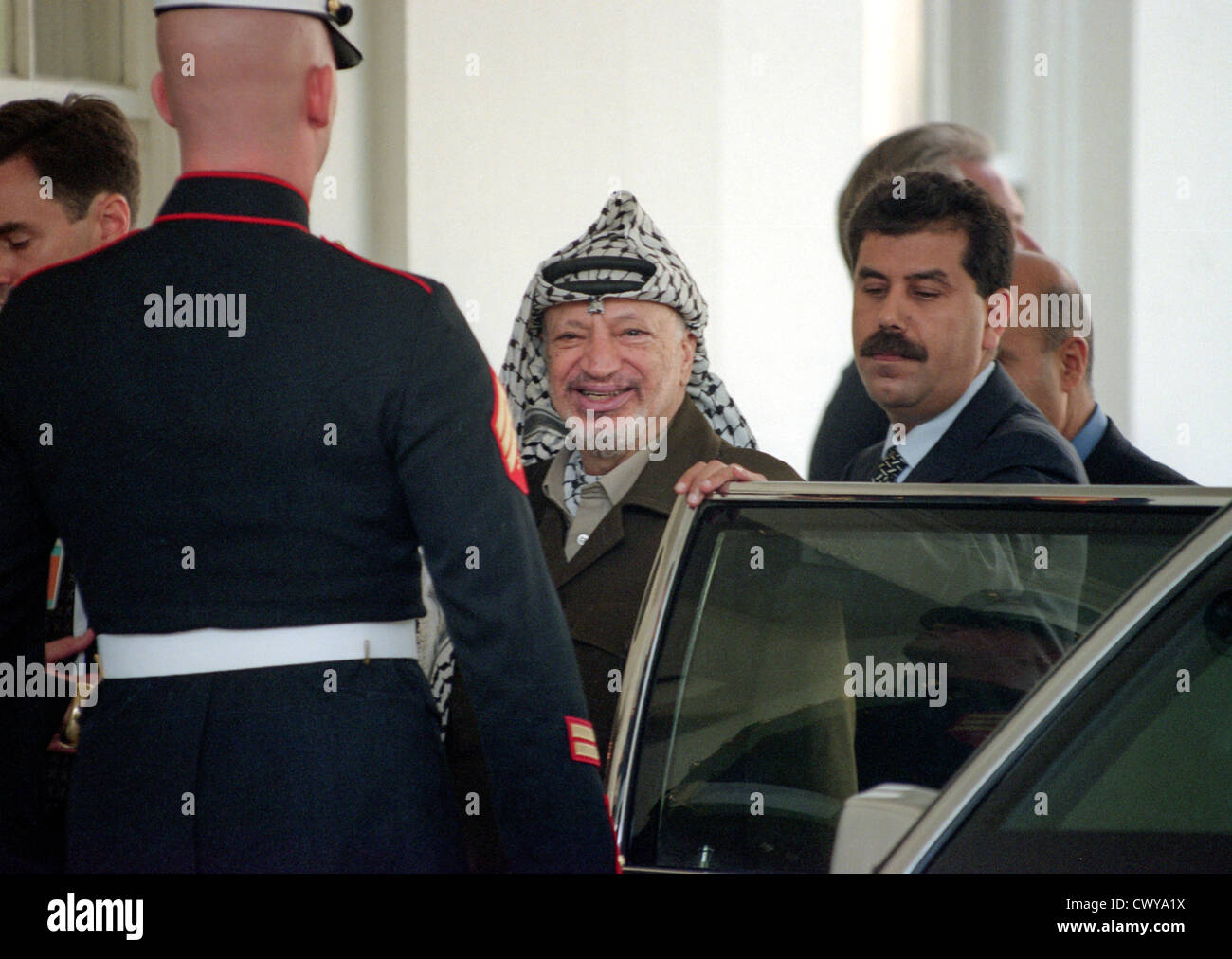 Palestinian leader Yasser Arafat salutes as he leaves the White House following a joint meeting with President Clinton and Israeli Prime Minister Benjamin Netanyahu September 28, 1998 in Washington, DC. Earlier, Israeli diplomats, speaking on condition of anonymity, said there was agreement that Israel would withdraw from an additional 13 percent of the West Bank -- adding to the 27 percent already promised to the Palestinians. Stock Photo