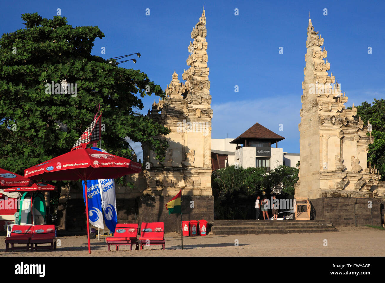 A traditional split gate, called a Candi Bentar, leading to Kuta Legian beach. The Pullman Hotel is in the background. Stock Photo