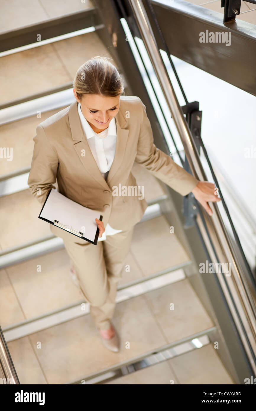 attractive young businesswoman walking down stairs Stock Photo - Alamy