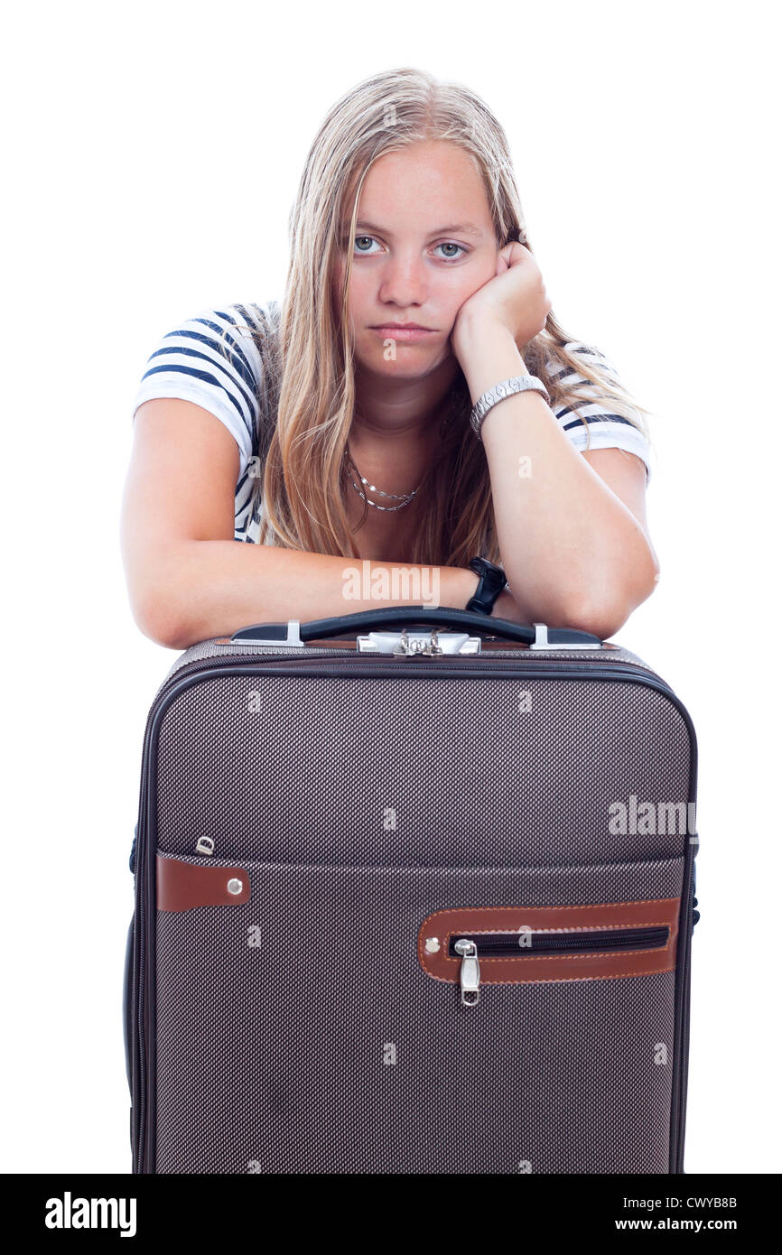 Bored young traveller tourist woman waiting with luggage, isolated on white background. Stock Photo