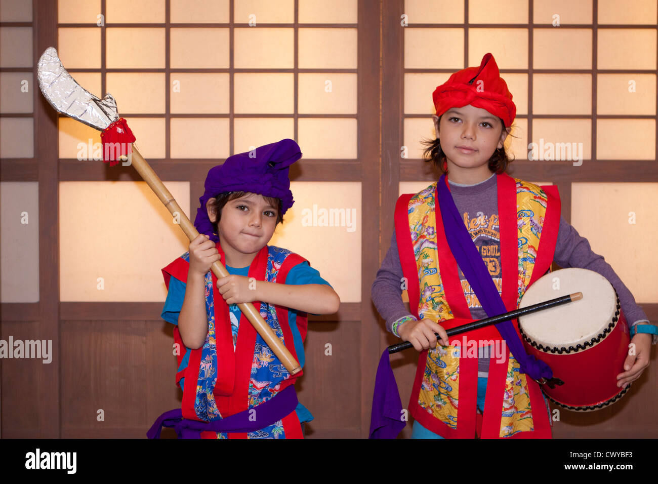 Two young children dress up in traditional Okinawa costume at the Ryukyu Mura theme park on Okinawa, Japan Stock Photo