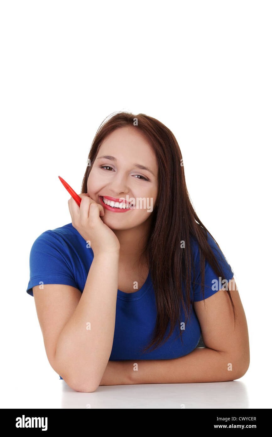 Smiling student girl sitting at the desk, isolated on white Stock Photo ...