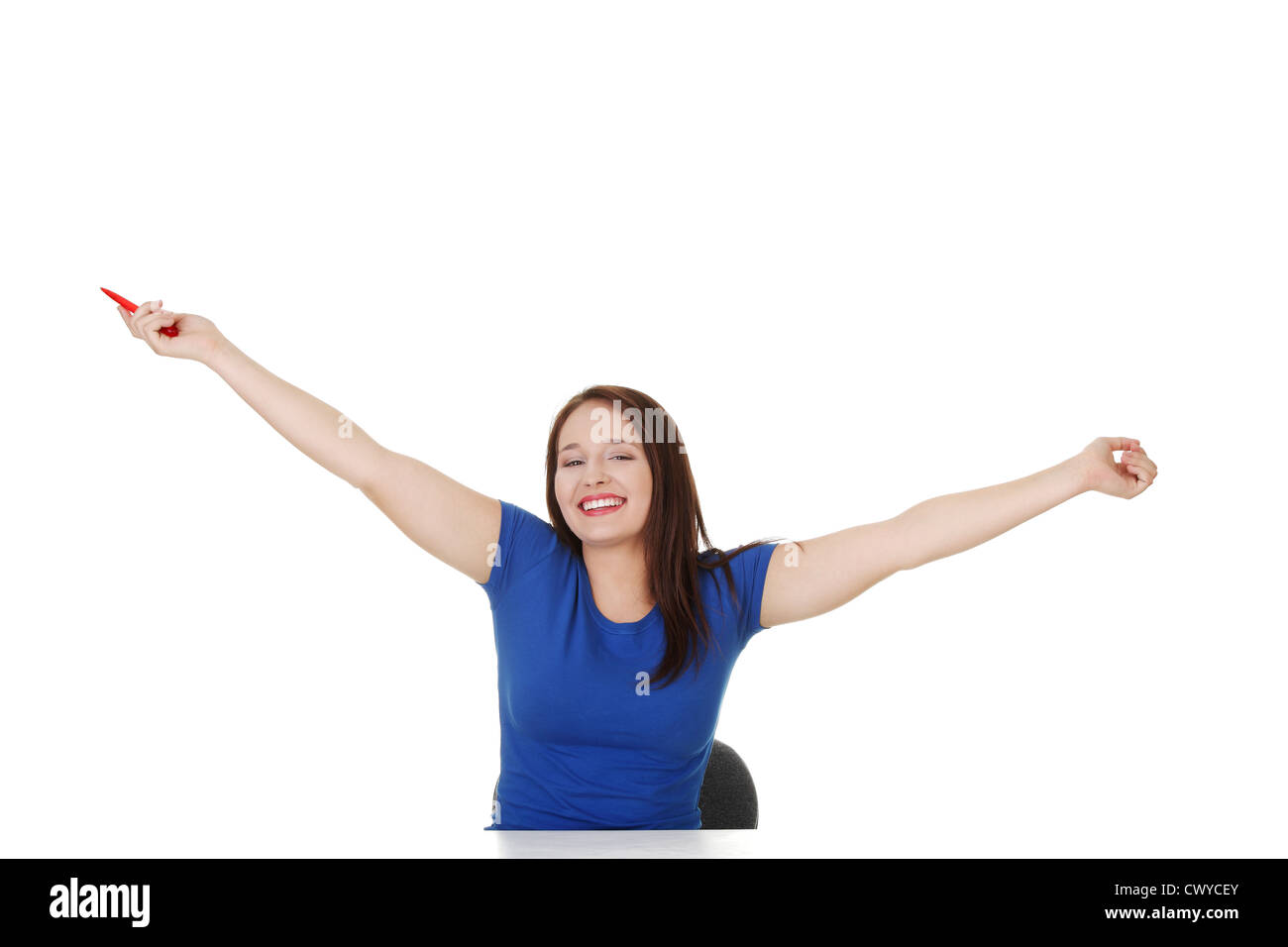 Smiling student girl sitting at the desk, isolated on white Stock Photo ...