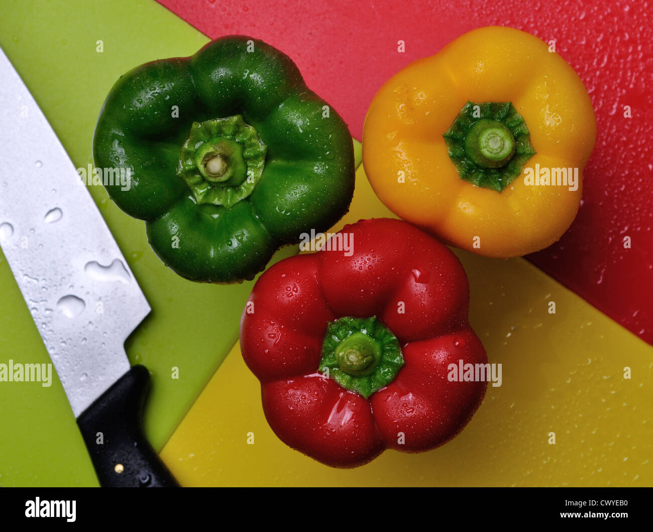 Red green and yellow bell peppers on chopping boards Stock Photo - Alamy