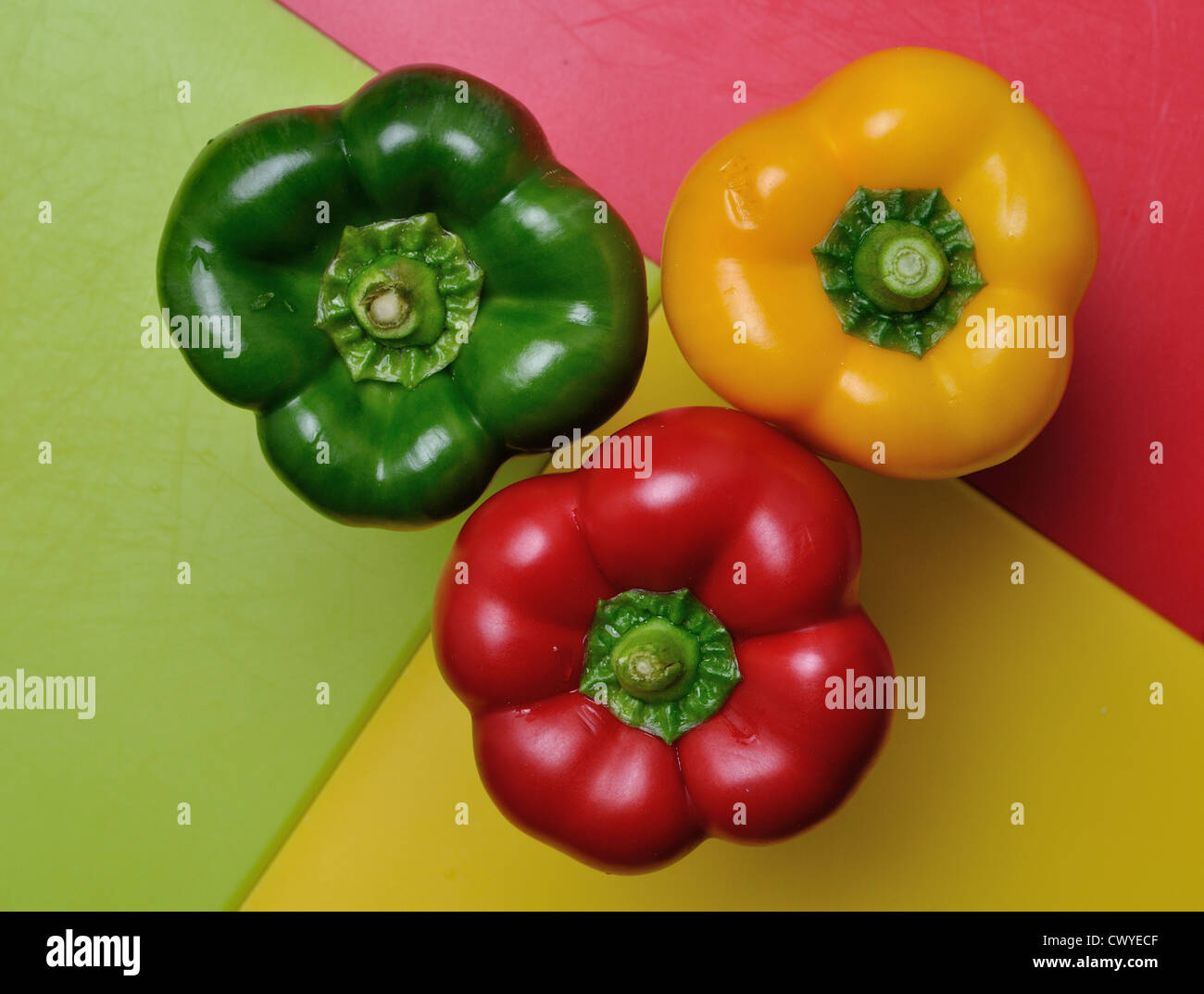 Red green and yellow bell peppers on chopping boards Stock Photo - Alamy