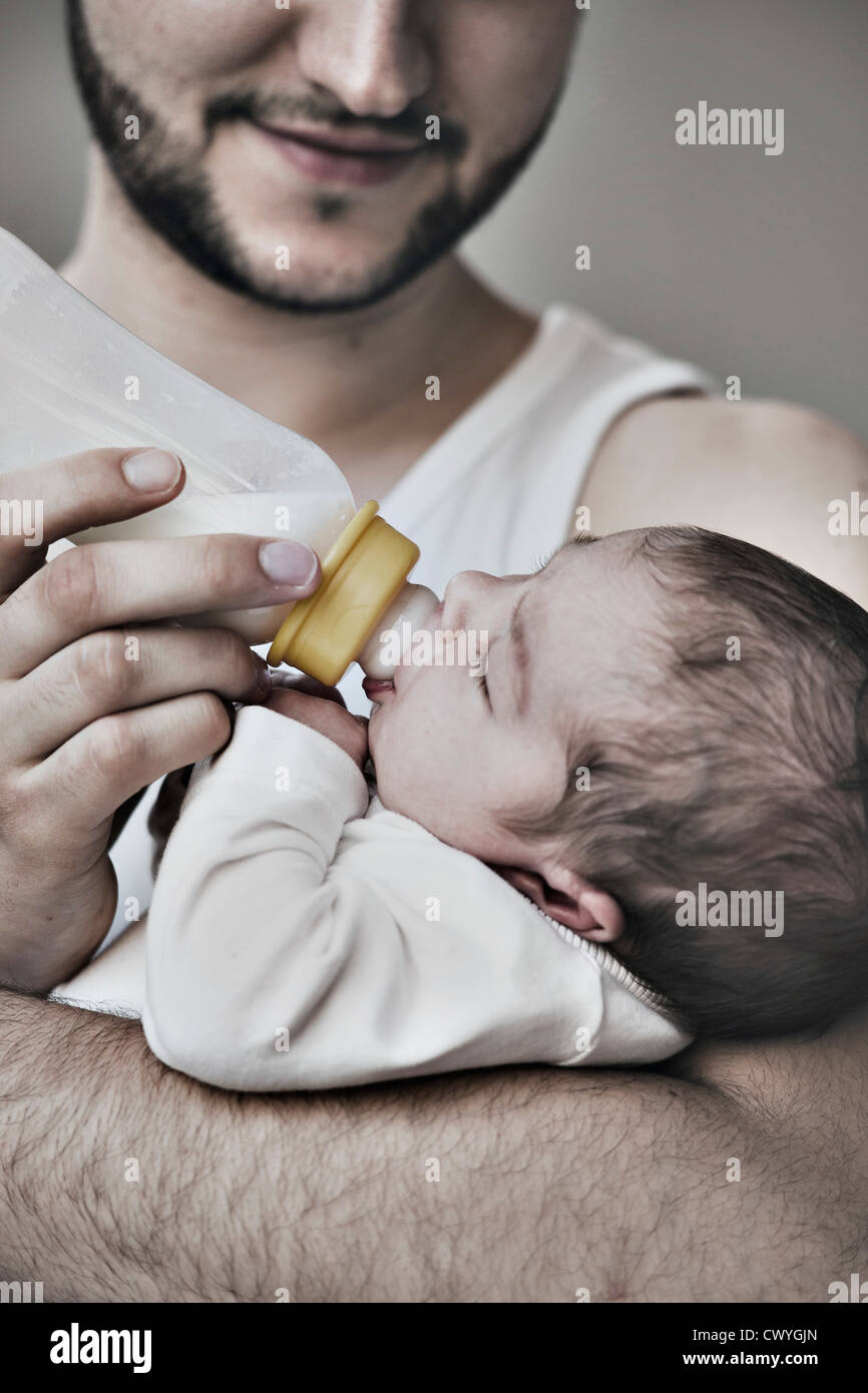 Father bottle-feeding two weeks old baby Stock Photo