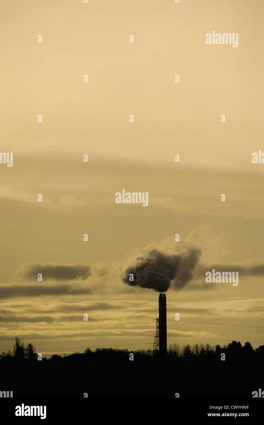 Silhouette of chimney stack and smoke Stock Photo
