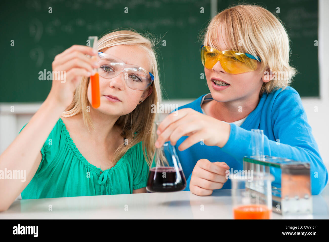 Schoolboy and schoolgirl experimenting in chemical class Stock Photo