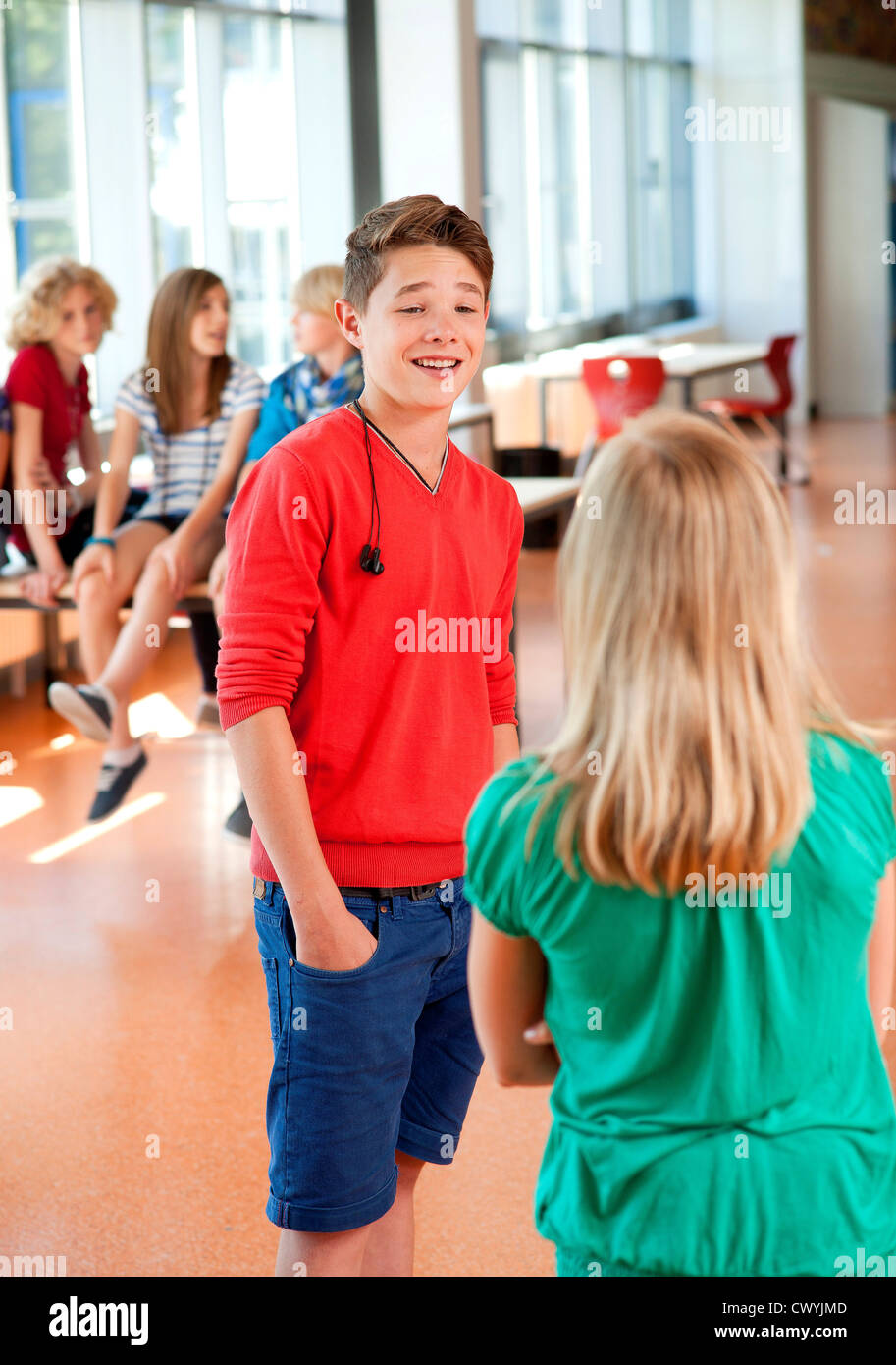 Teenage boy smiling at teenage girl in school Stock Photo - Alamy