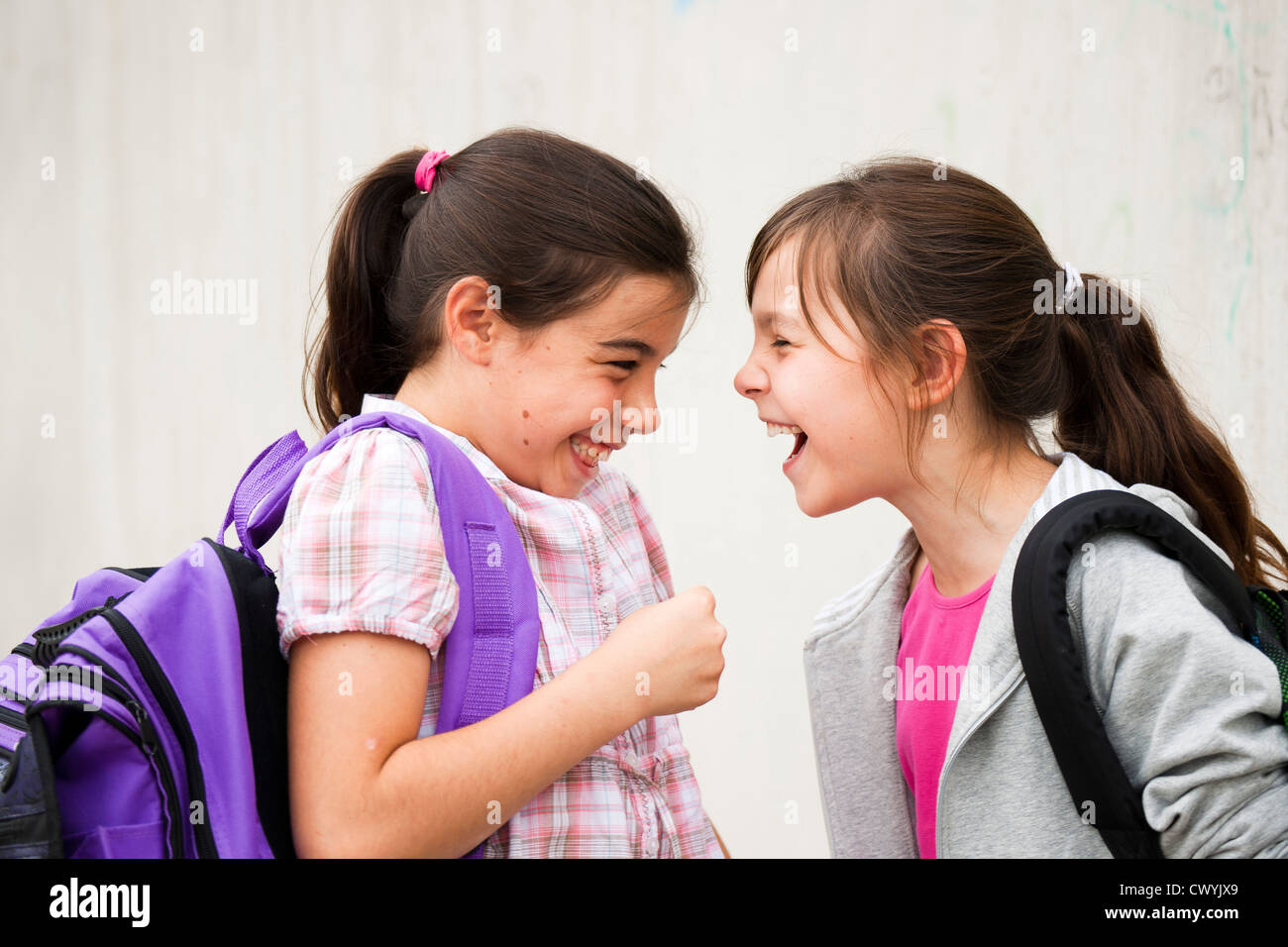 Two laughing girls looking at each other Stock Photo