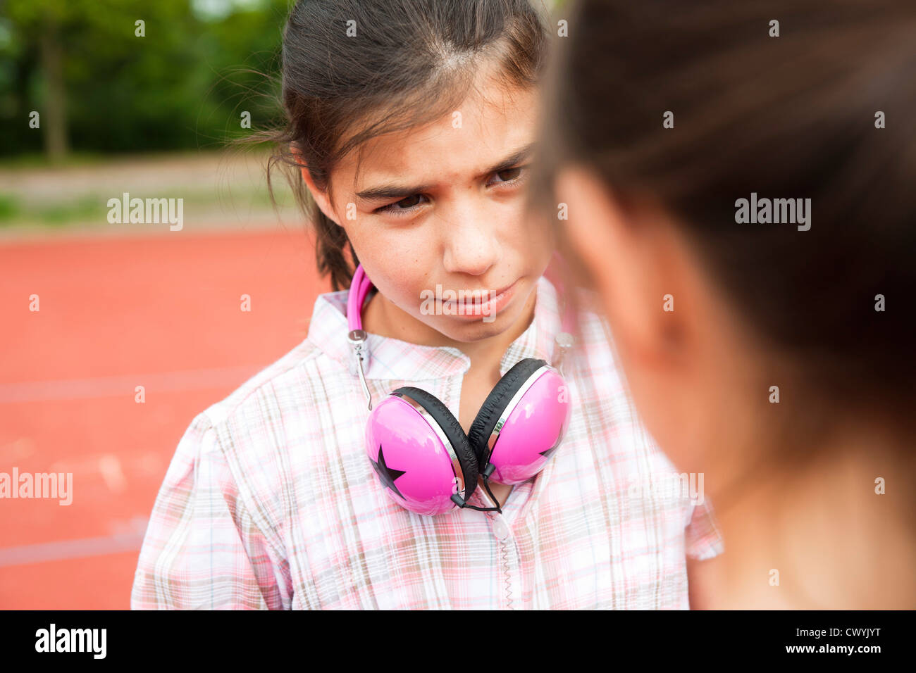 Girl looking seriously at another girl Stock Photo