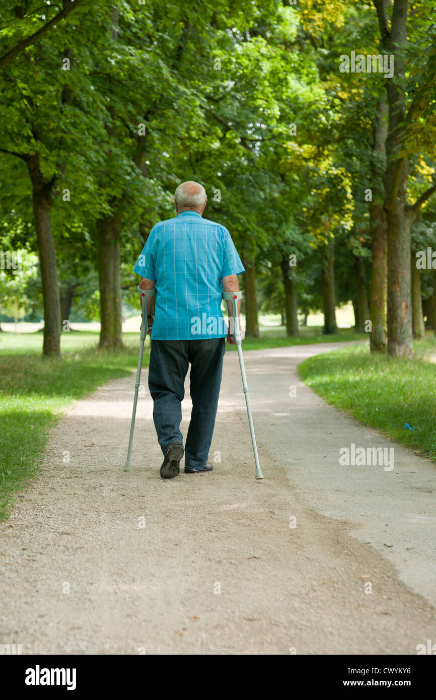 Old man walking in park Stock Photo