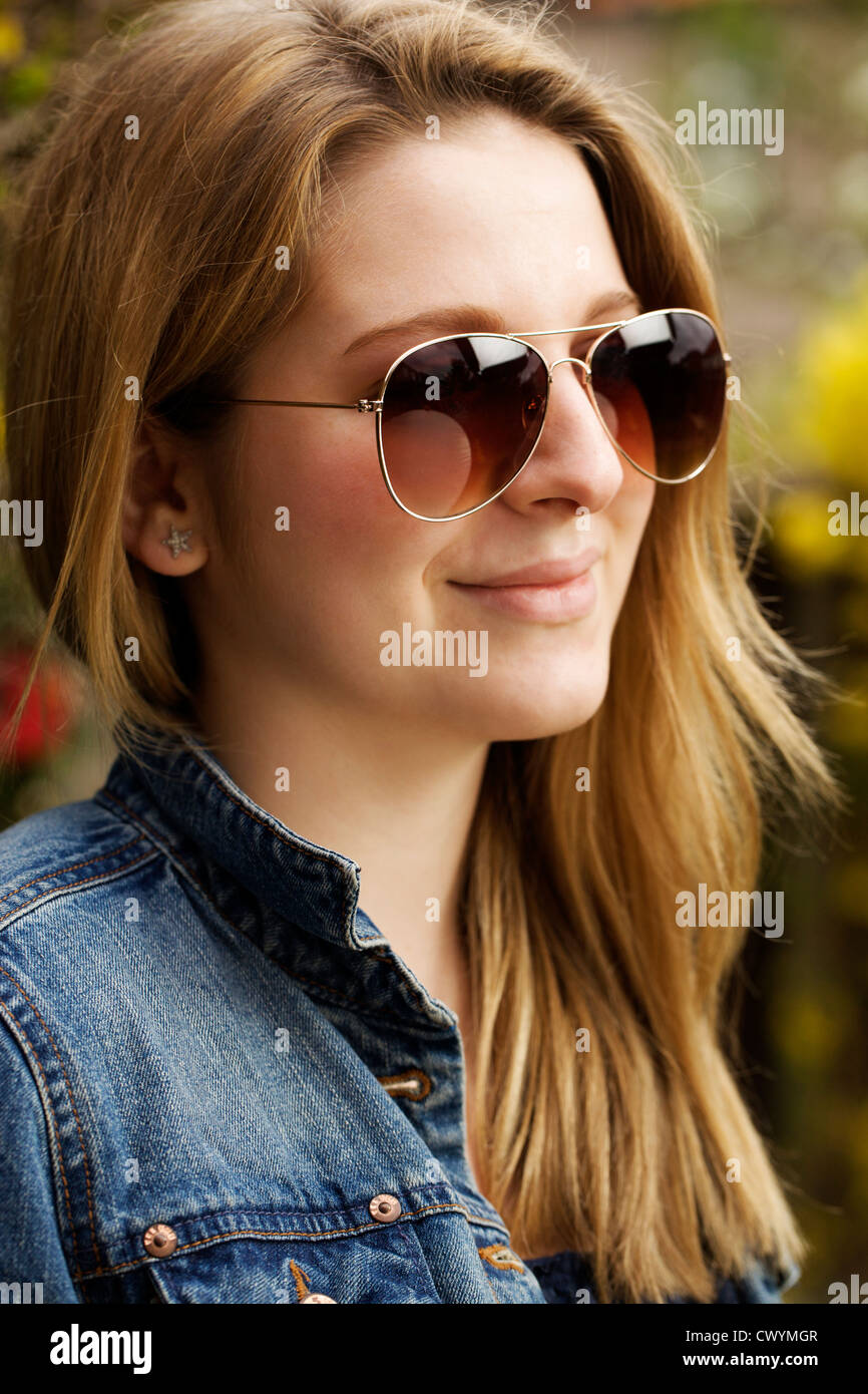 A fashion image of a teenage a girl wearing aviators. Stock Photo