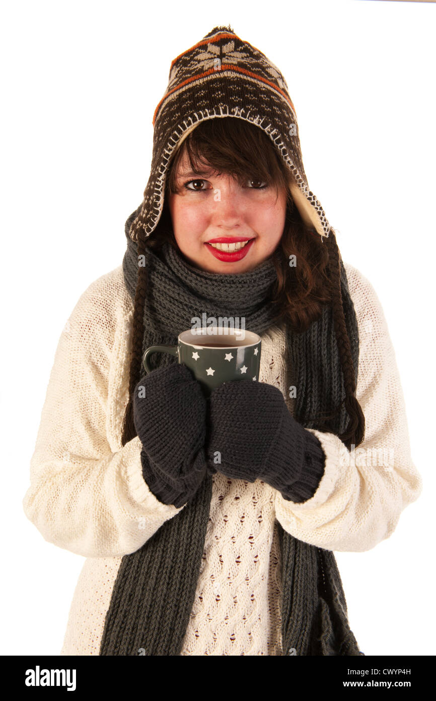 Winter girl with wool sweater ice cap and gloves drinking hot chocolate