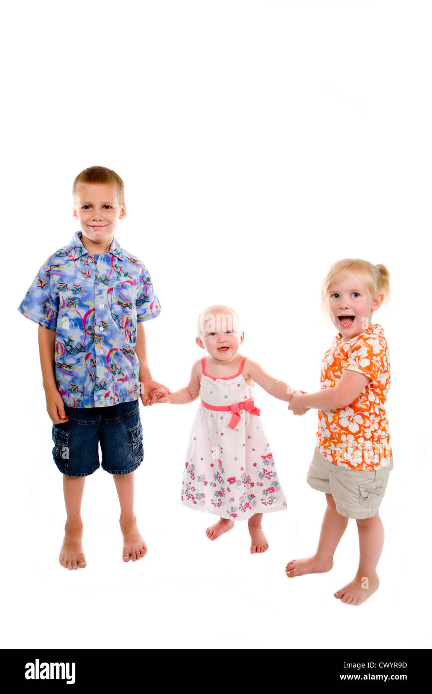 Three children holding hands Stock Photo