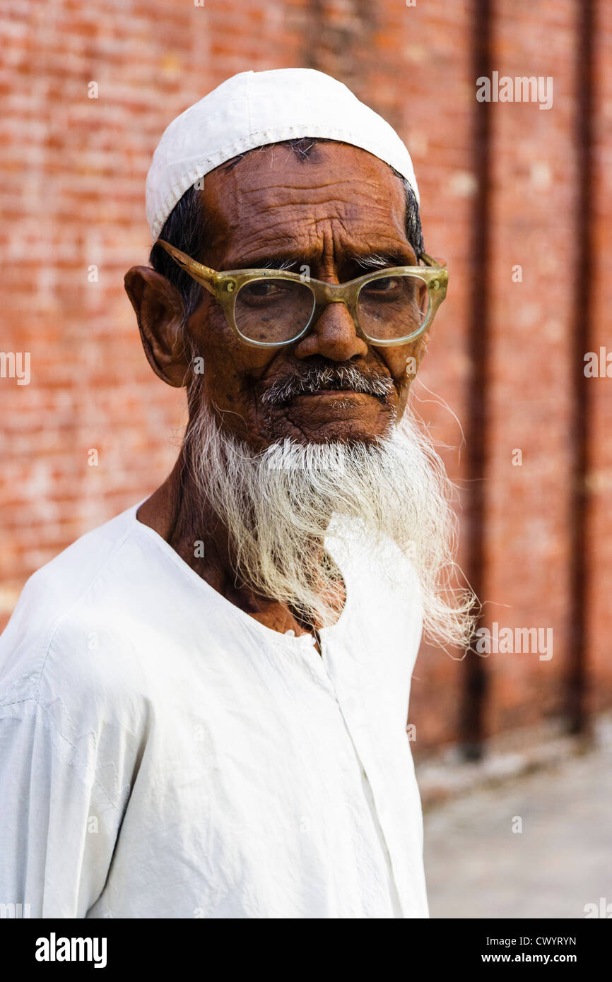 Portrait of old bearded Bangladeshi man by Shait Gumbad Mosque in Bagerhat, Bangladesh Stock Photo