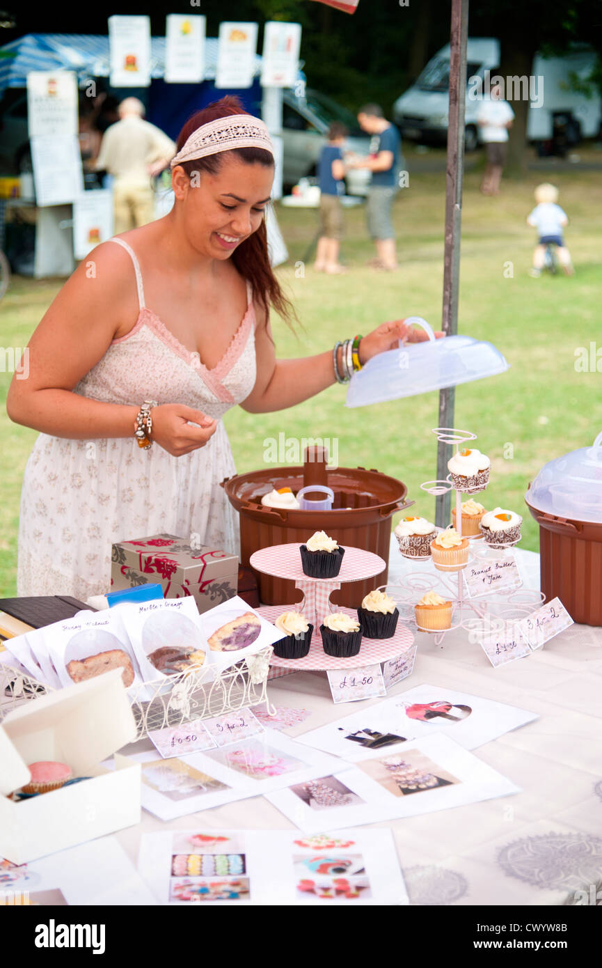Attractive young woman on a cupcake and greetings cards stall at Muswell Hill Festival - London - 2012 Stock Photo