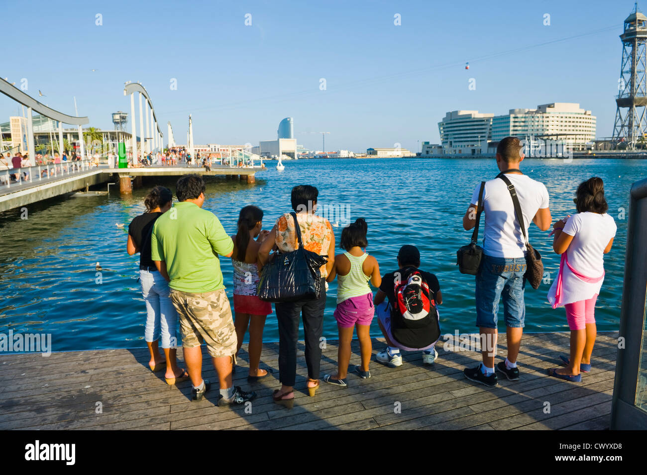 Barcelona people. Tourists looking out at the harbour Port Vell Barcelona Catalonia Spain ES Stock Photo