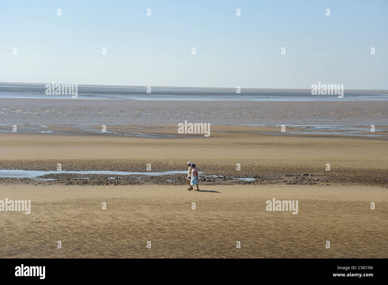 Couple walking on beach, Burnham-on-Sea, Somerset, England, United Kingdom Stock Photo