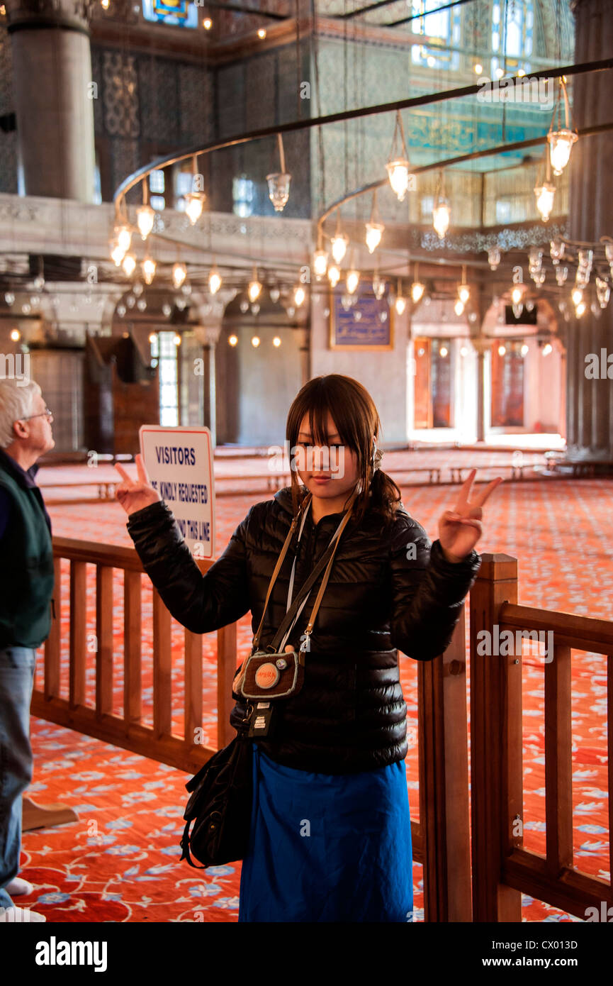 Asian tourists inside the Blue Mosque  in Istanbul Stock Photo
