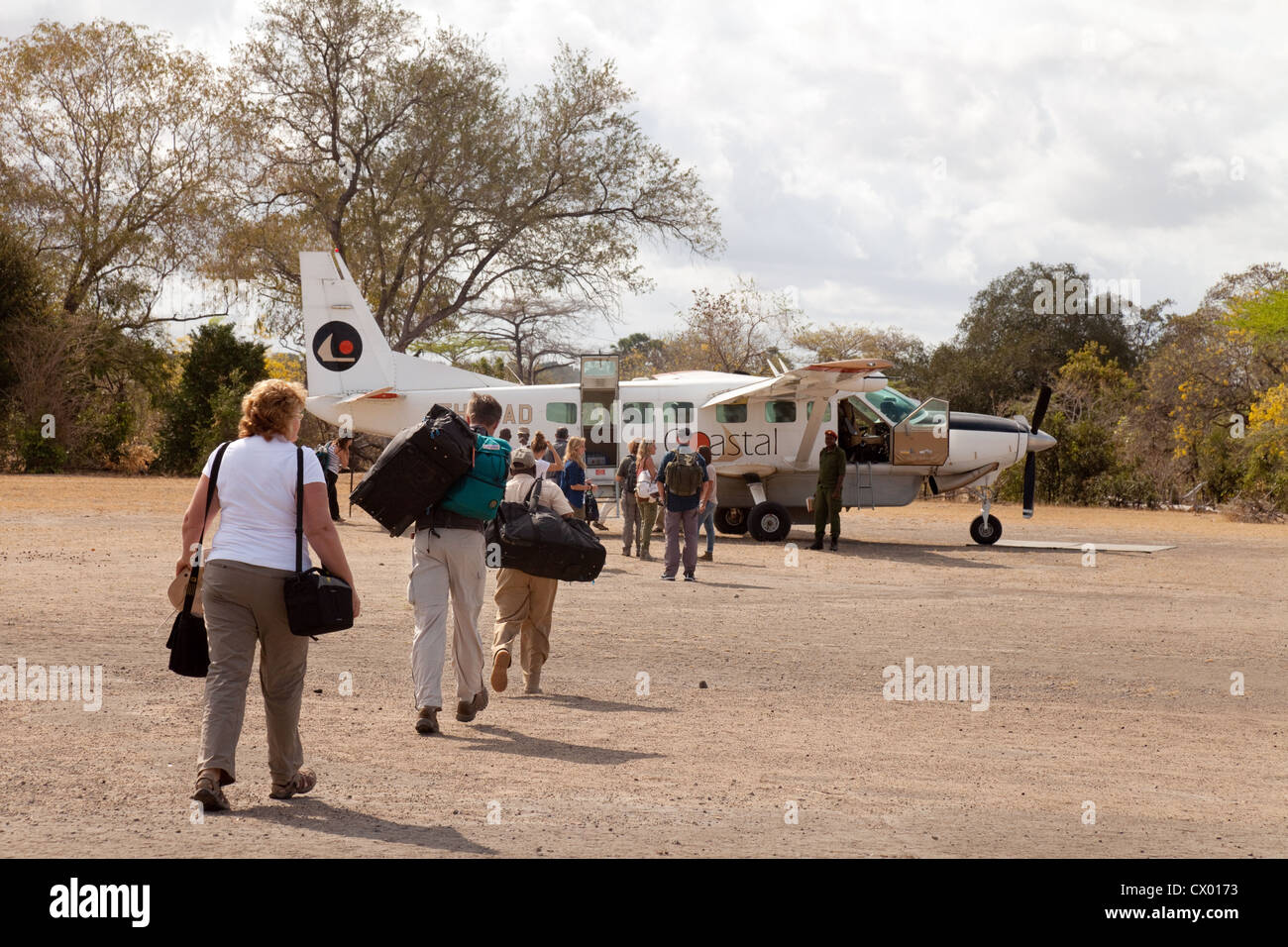 Tourists getting a light Cessna aircraft flight from the airstrip in the Selous Game reserve, Tanzania Africa Stock Photo