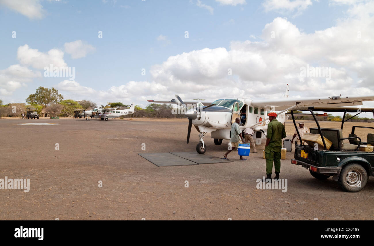 Light aircraft on the Selous Game reserve airstrip bringing safari tourists, Tanzania Africa Stock Photo