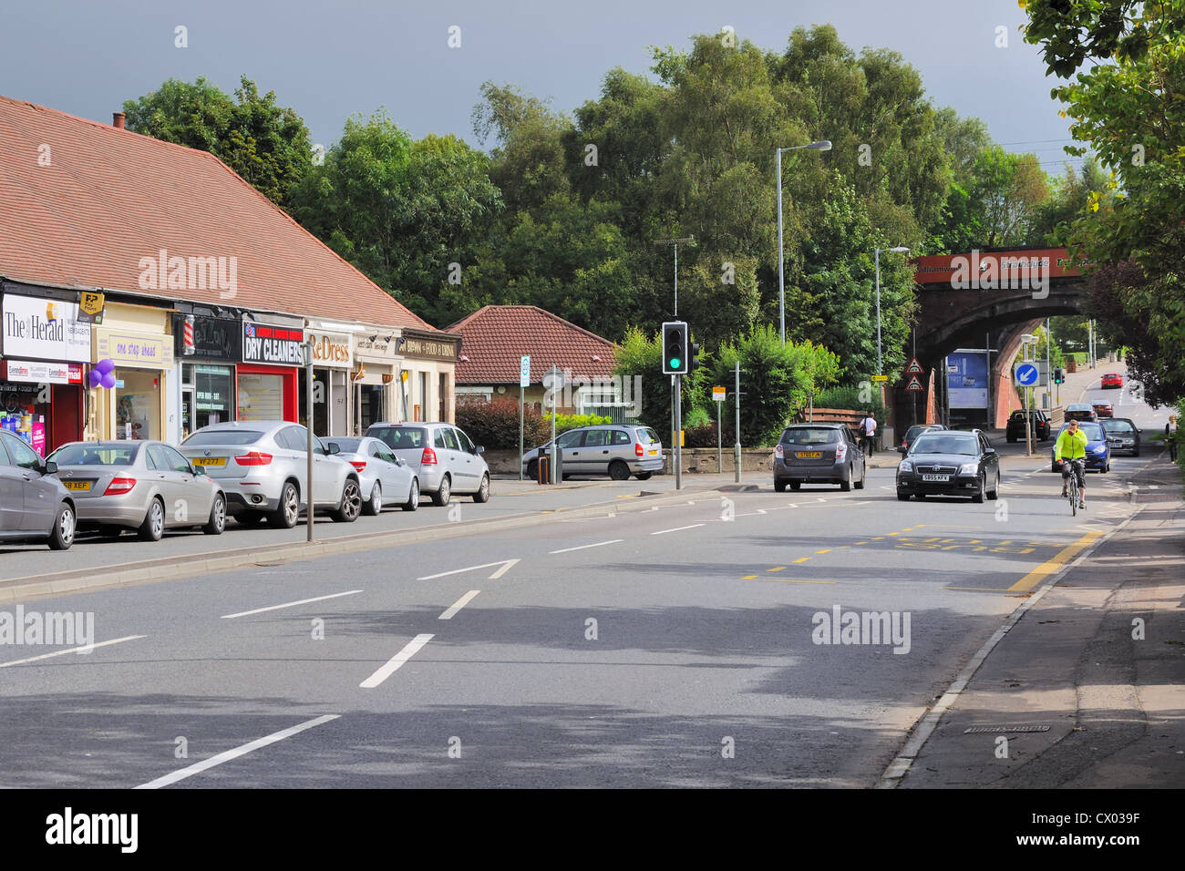 Eastwoodmains Road, shops and railway bridge at Williamwood Stock Photo
