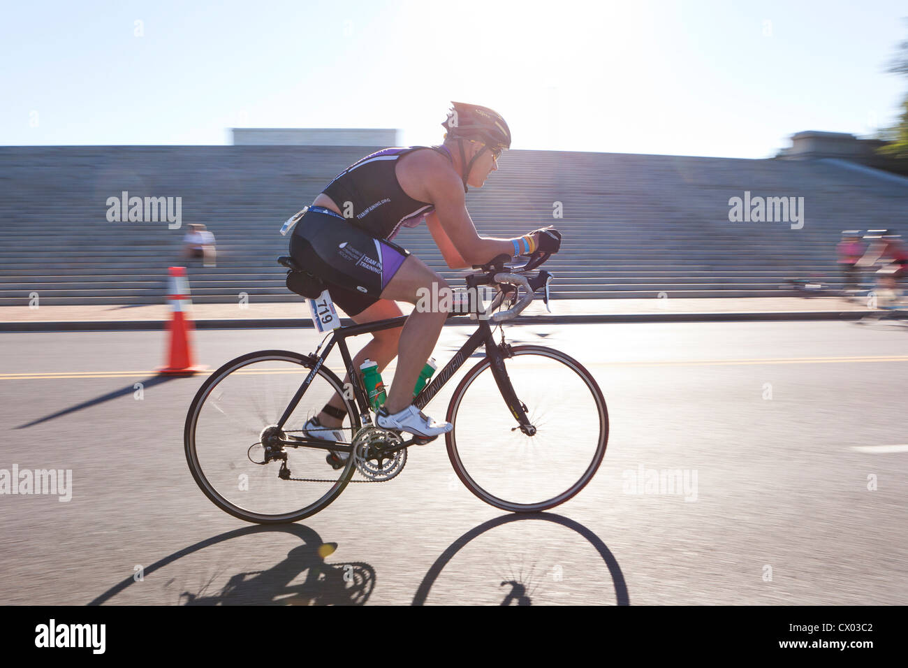 Cyclist racing in bright sun light - USA Stock Photo