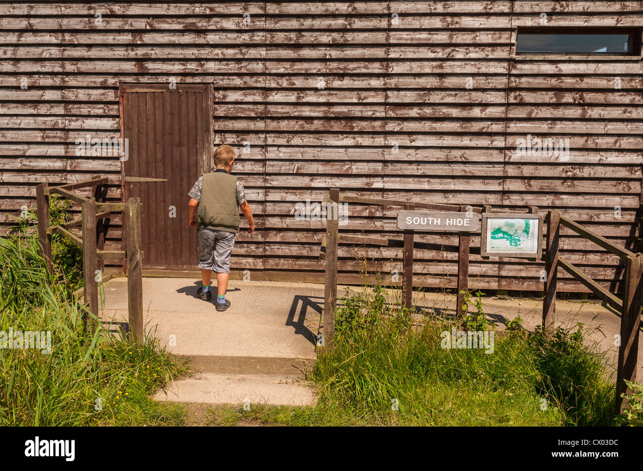 A boy entering the south hide at the Minsmere RSPB bird reserve in Suffolk , England , Britain , Uk Stock Photo