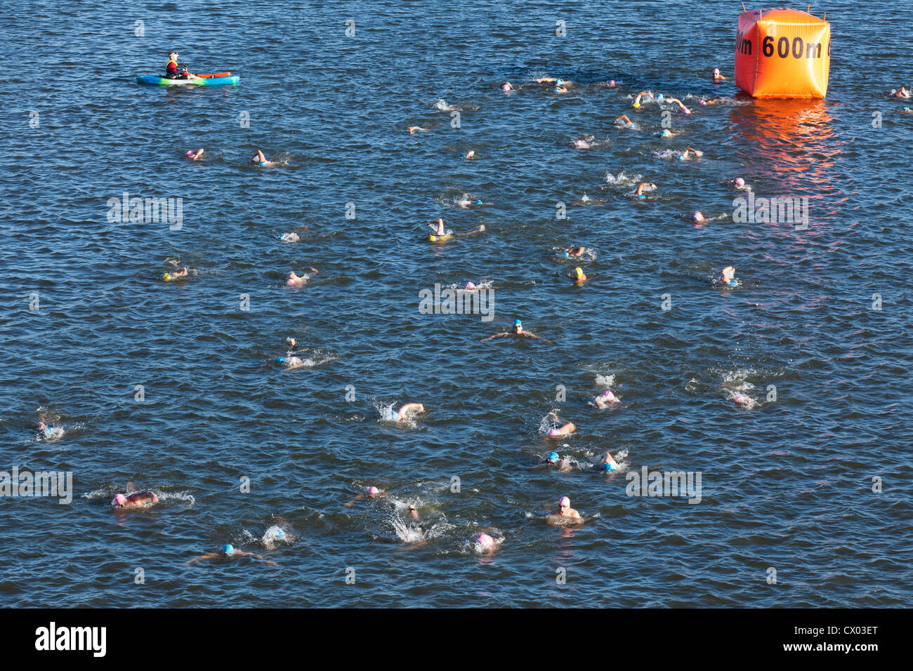 Triathlon swimmers racing in river Stock Photo - Alamy