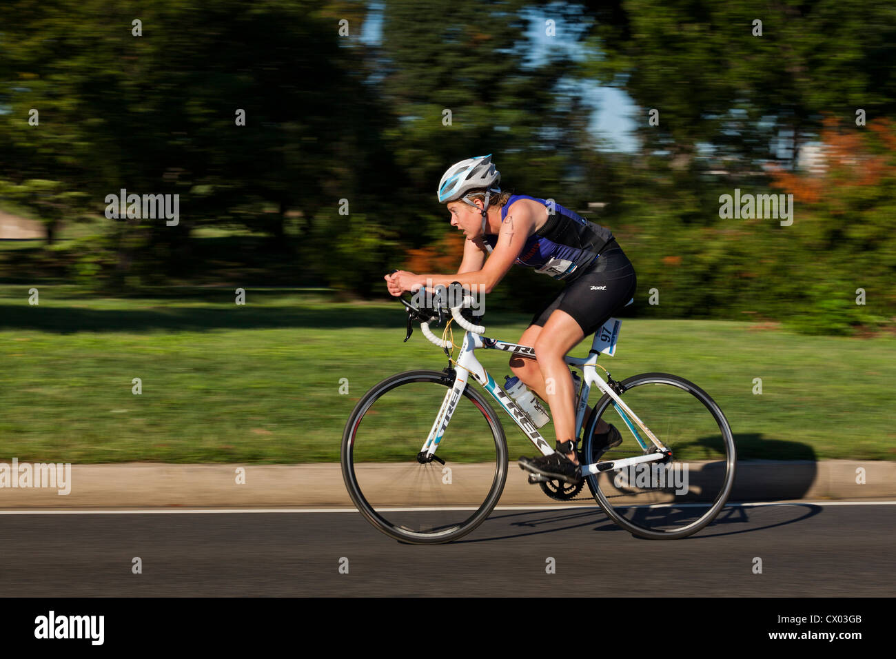 Female cyclist racing in bike race - USA Stock Photo
