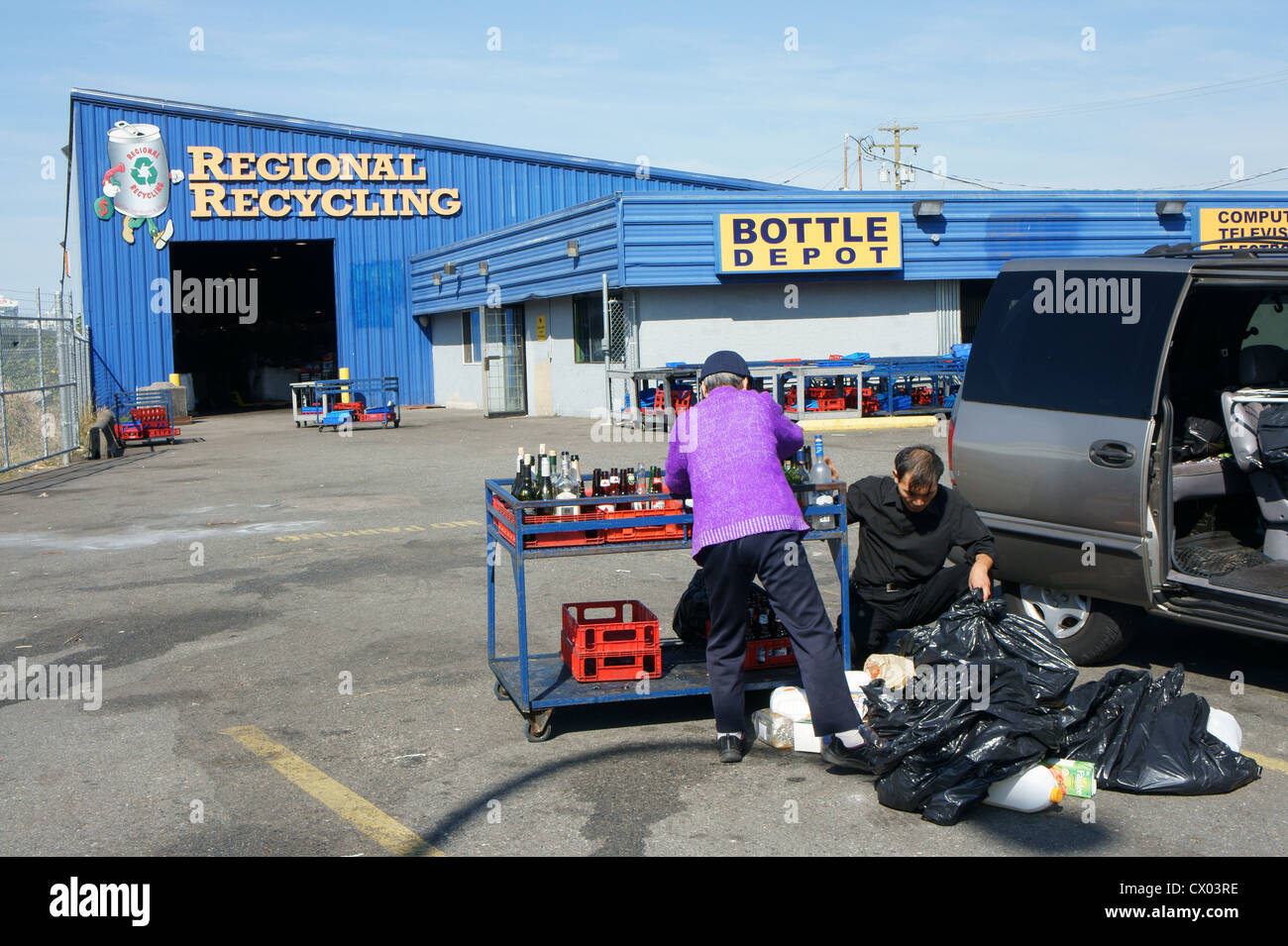 Chinese people sorting glass bottles, at a recycling depot in Vancouver