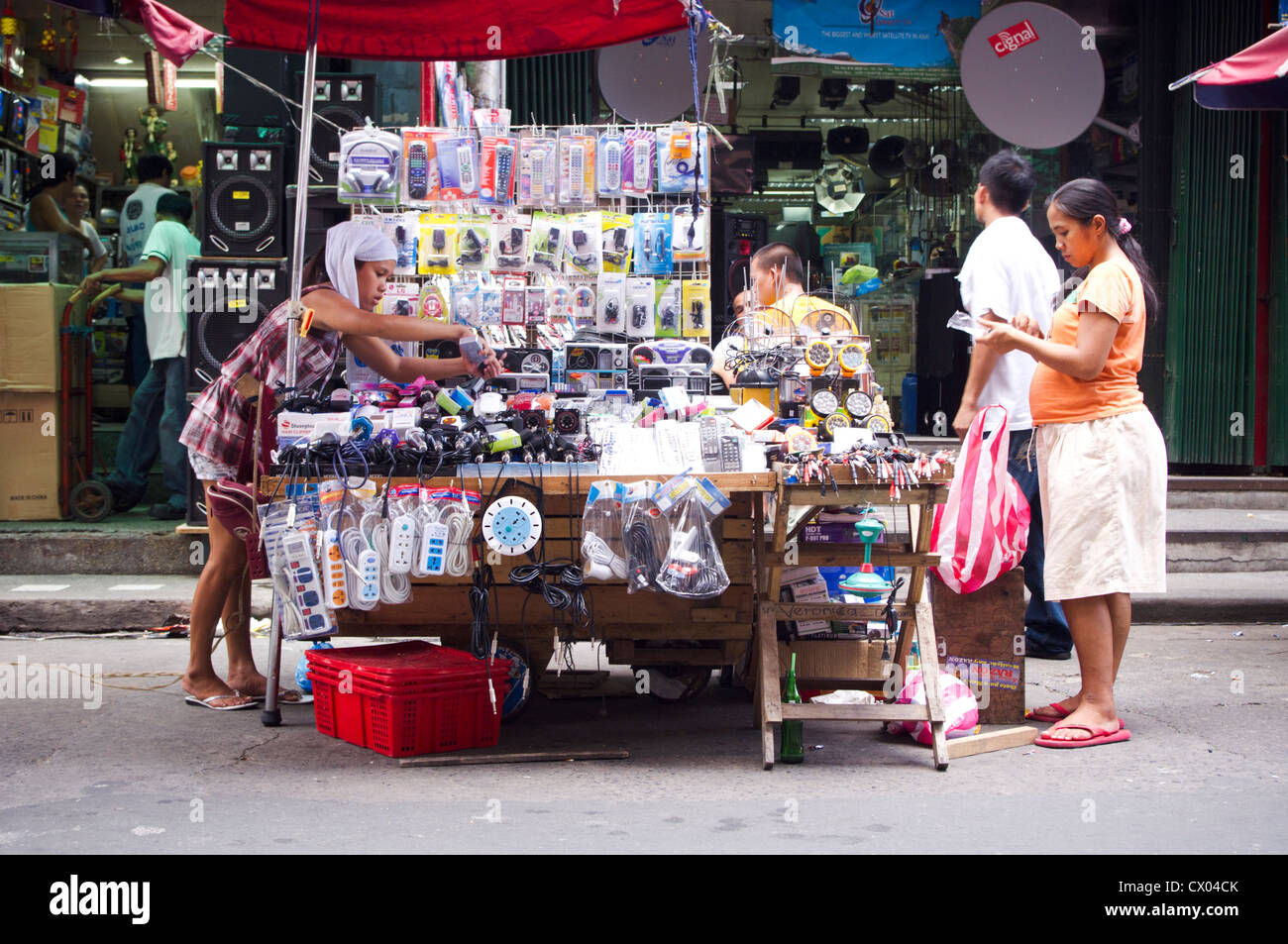 asian street vendor, selling many products on a stall, philippines