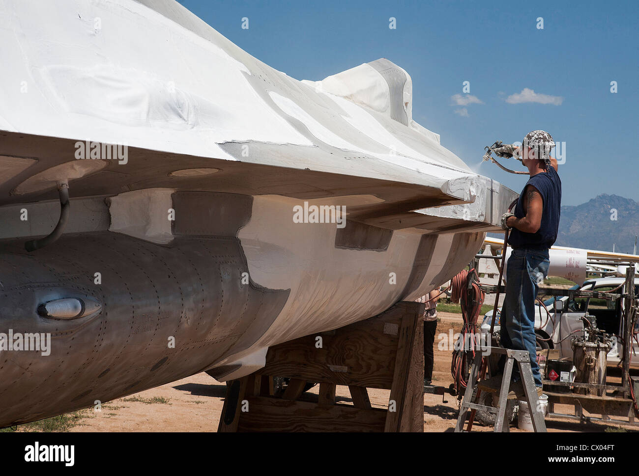 A worker prepares an aircraft for storage at the 309th Aerospace Maintenance and Regeneration Group at Davis-Monthan AFB. Stock Photo