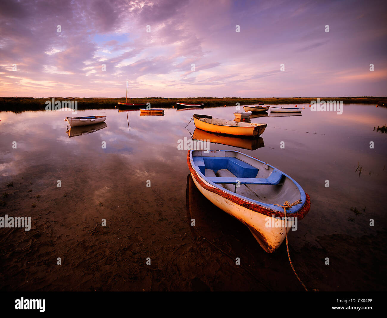 Boats in Morston quay at sunset Stock Photo