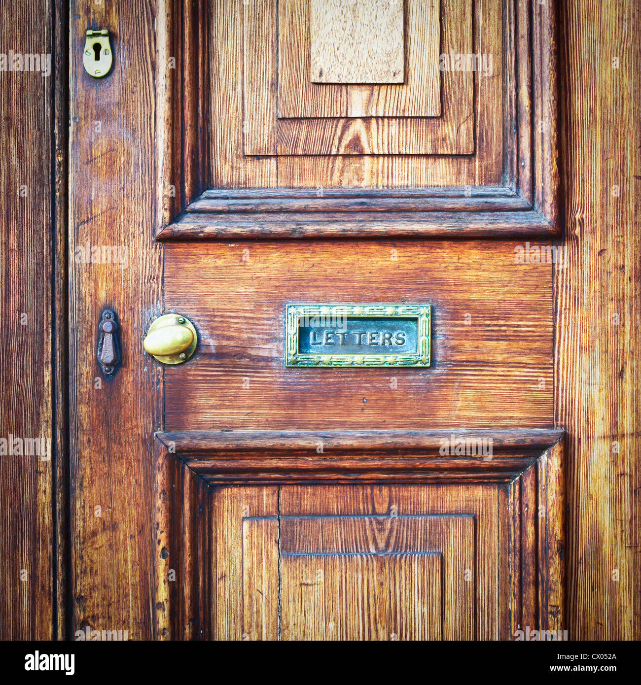 A wooden vintage front door with a letter box Stock Photo