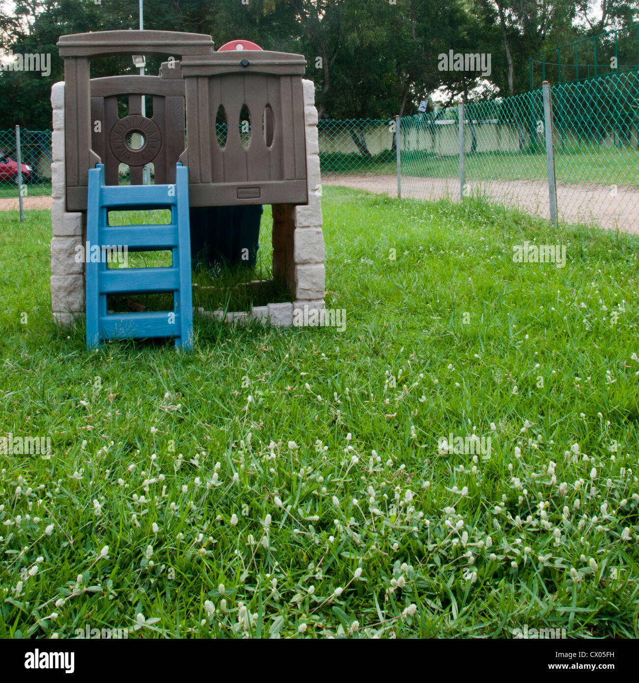 Toy house with ladder in a park Stock Photo