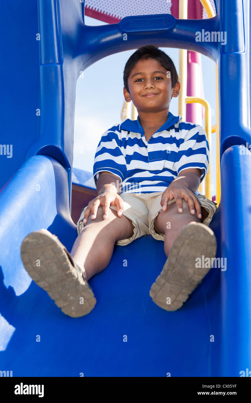 Outdoor portrait of a cute little indian boy at playground Stock Photo