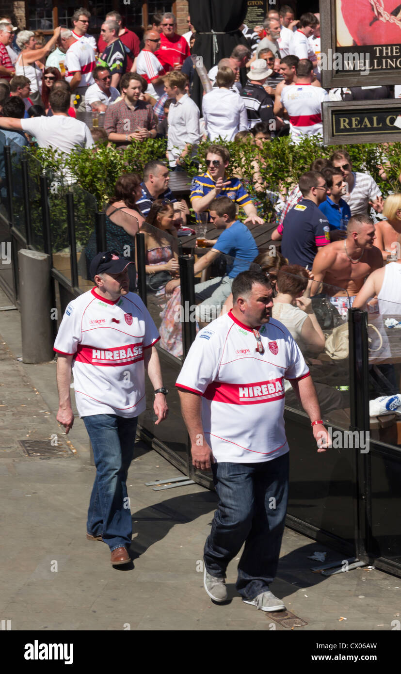 Two Hull Kingston Rovers rugby league football club fans walk past pub