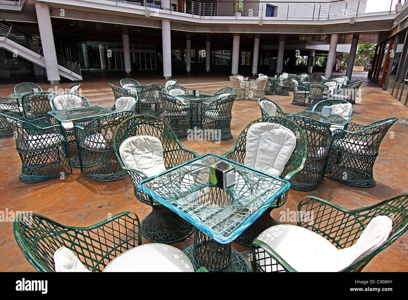wicker tables and chairs in green Stock Photo - Alamy