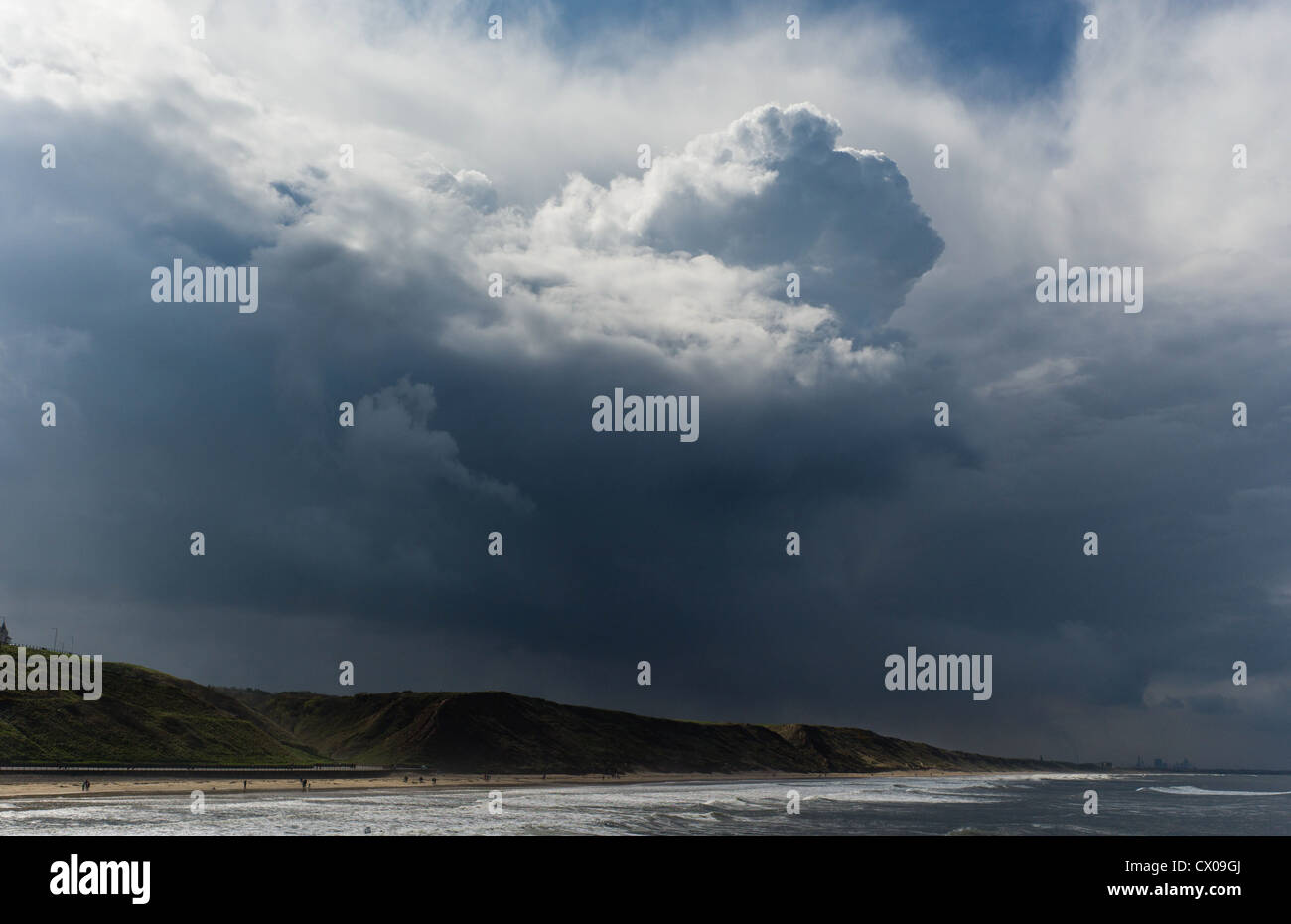 Storm clouds form over a beach on Teesside Stock Photo